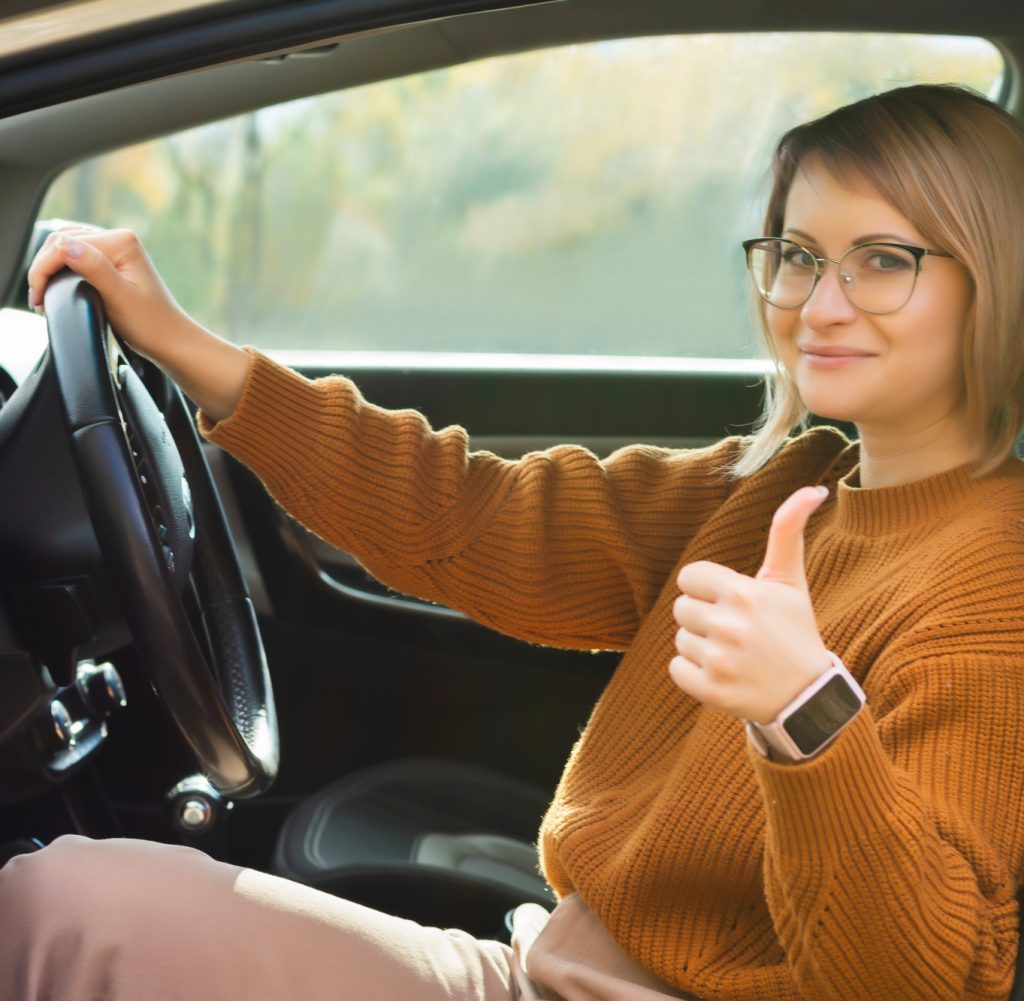 Driving school woman successfully passed exam in driving school looking sitting in car
